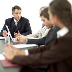 Businessman Conducting a Meeting with His Staff